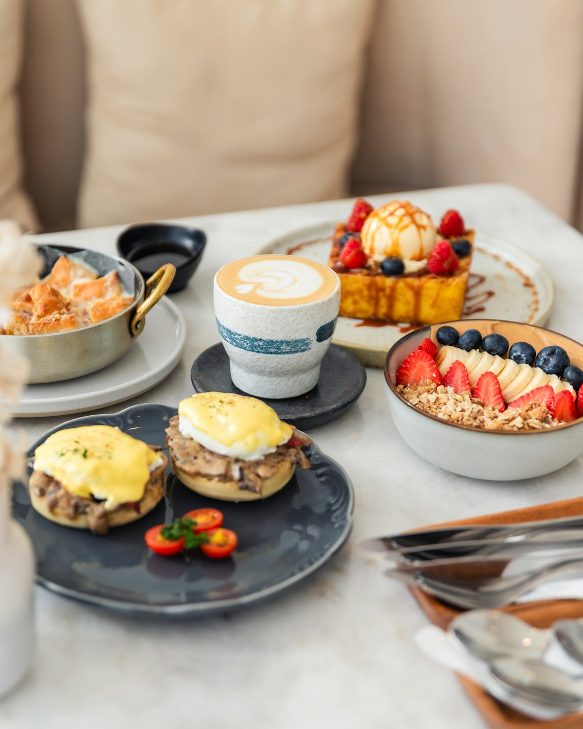 Gourmet brunch spread with eggs benedict and French toast.